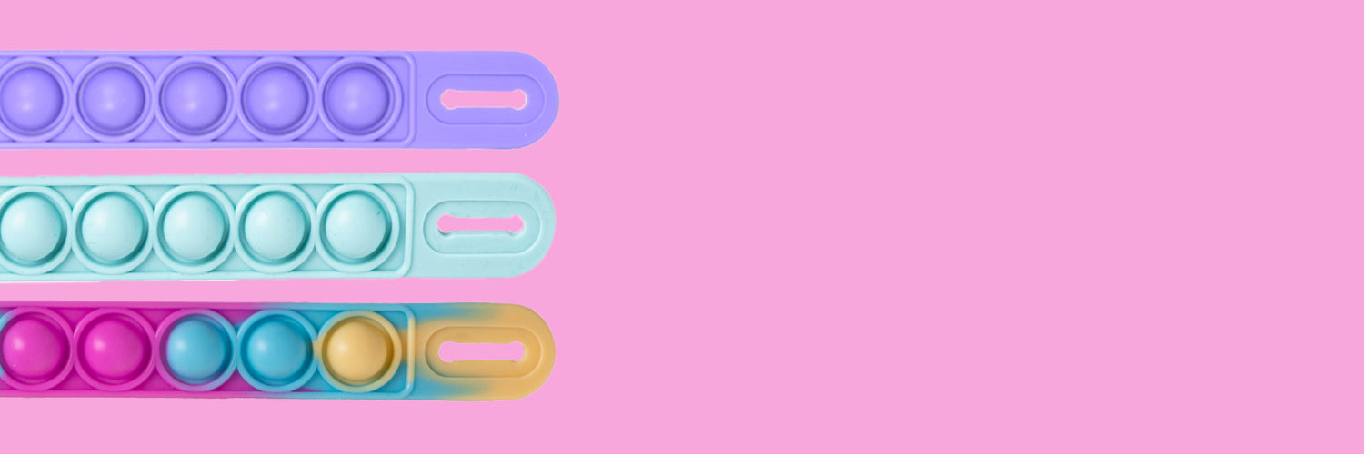 Colorful silicone accessories in purple, mint, and rainbow