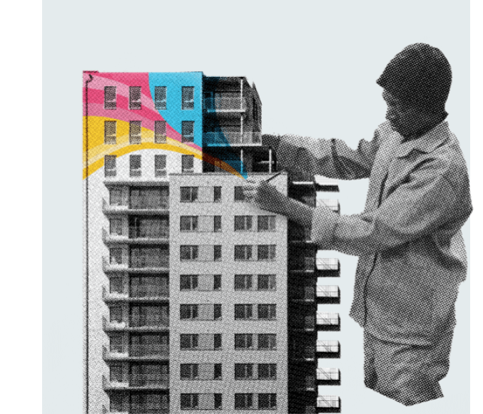 Person painting colorful sections on a tall wall