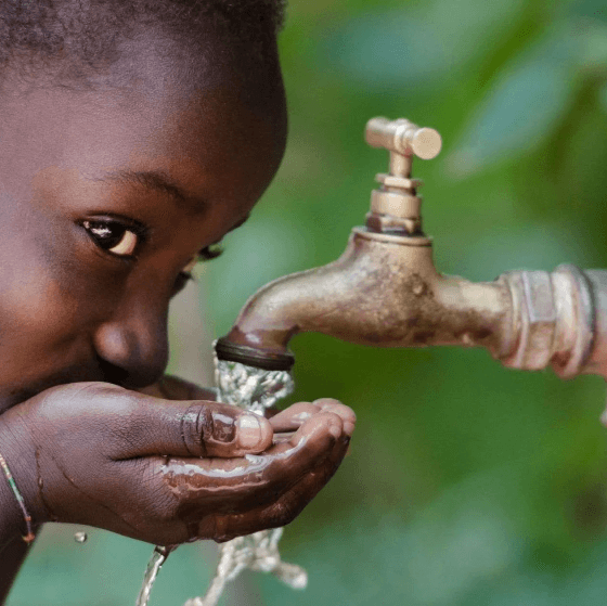 Child drinking clean water outdoors